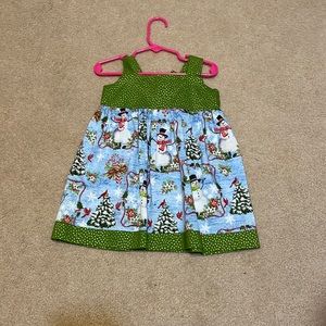 Green polka dot Christmas dress with adjustable straps and ties in the back